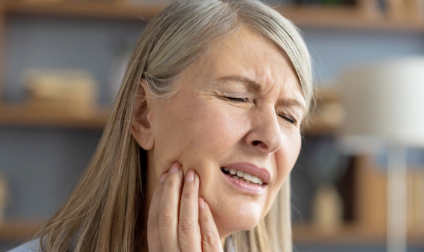 Patient experiencing tooth pain due to delayed dental care in Bellevue WA highlighting importance of early dental visits