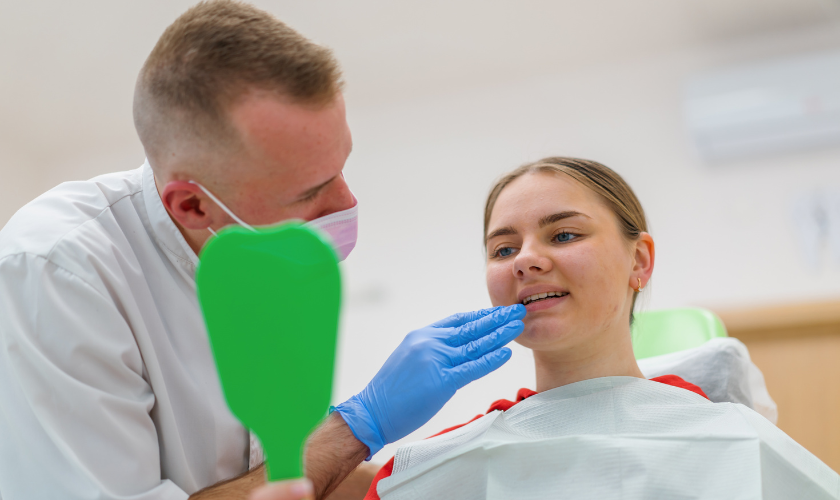 Dentist in Bellevue WA examining patient during a routine dental checkup in a modern clinic setting